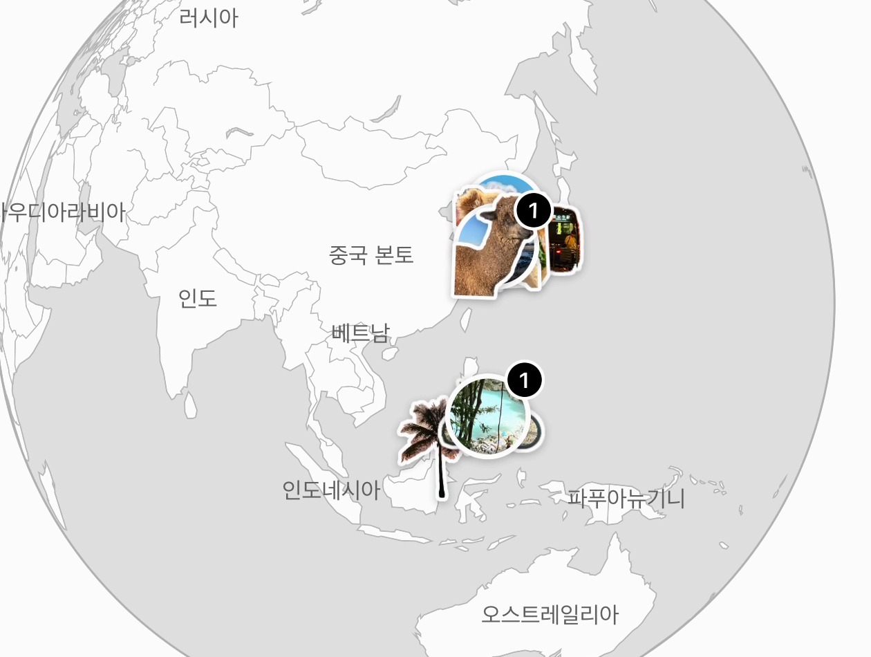 iOS 출시 준비 중(테스트버전 화면). 문득 지구 탭의 지구본. 아시아 위에 다녀온 도시마다 사진 스티커가 붙어 있다.